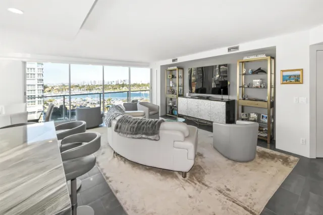 a living room with furniture and large windows