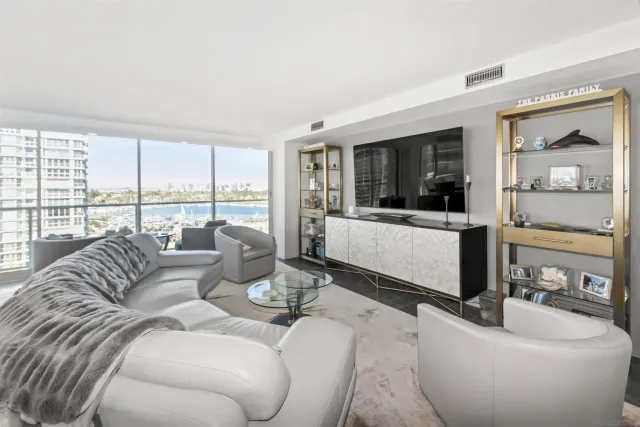 a living room with furniture and large windows