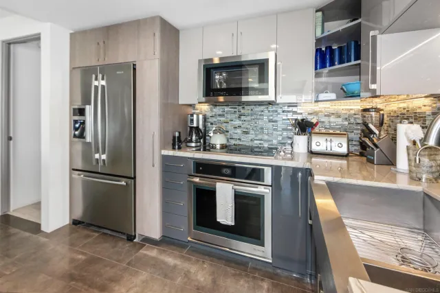 a kitchen with stainless steel appliances granite countertop a refrigerator stove and microwave