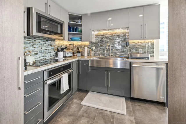 a kitchen with stainless steel appliances granite countertop a stove sink and cabinets