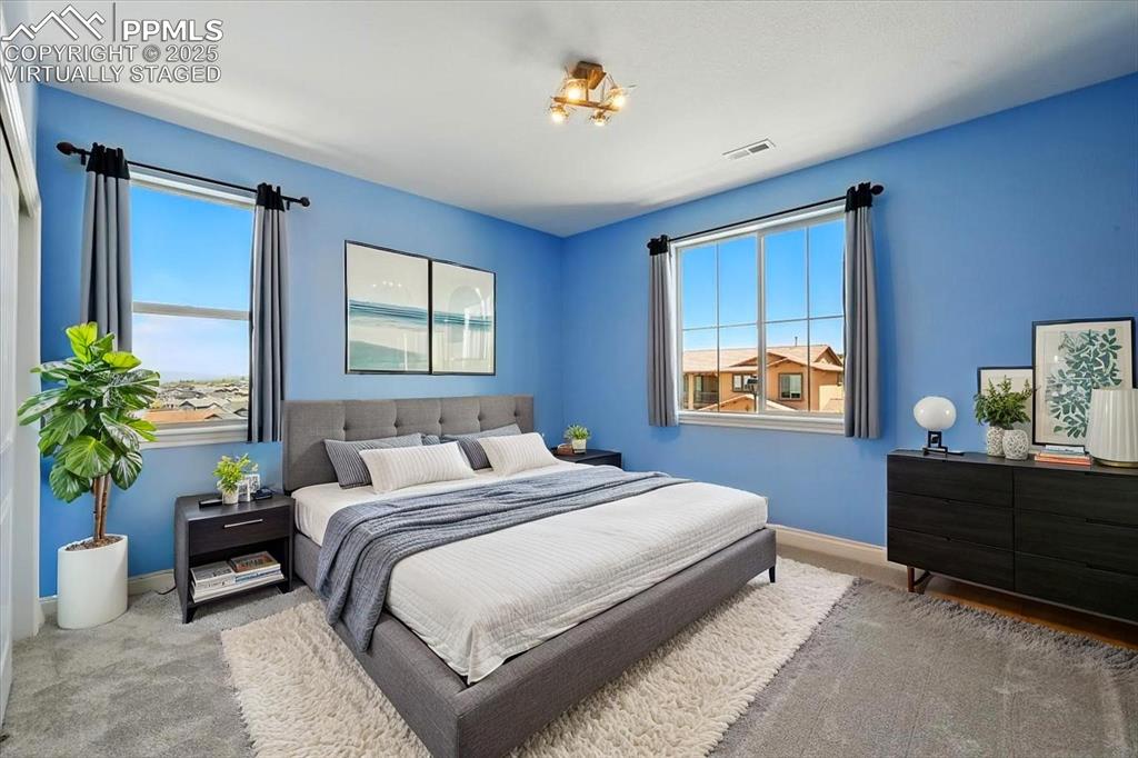 4577 Outlook Ridge Trail Colorado Springs, CO 80924 - Photo 30 of 45 a bedroom with a bed table chair and a window