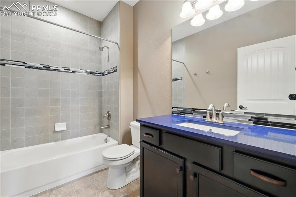 4577 Outlook Ridge Trail Colorado Springs, CO 80924 - Photo 39 of 45 a bathroom with a sink a toilet a mirror a bathtub and shower
