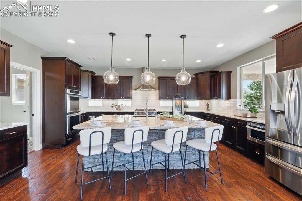 4577 Outlook Ridge Trail Colorado Springs, CO 80924 - Photo 5 of 45 a large kitchen with a table and chairs