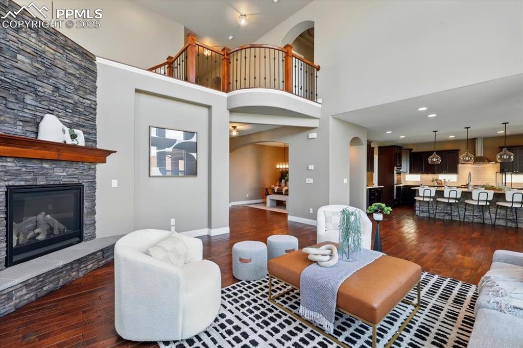 4577 Outlook Ridge Trail Colorado Springs, CO 80924 - Photo 10 of 45 a living room with furniture a fireplace and a flat screen tv