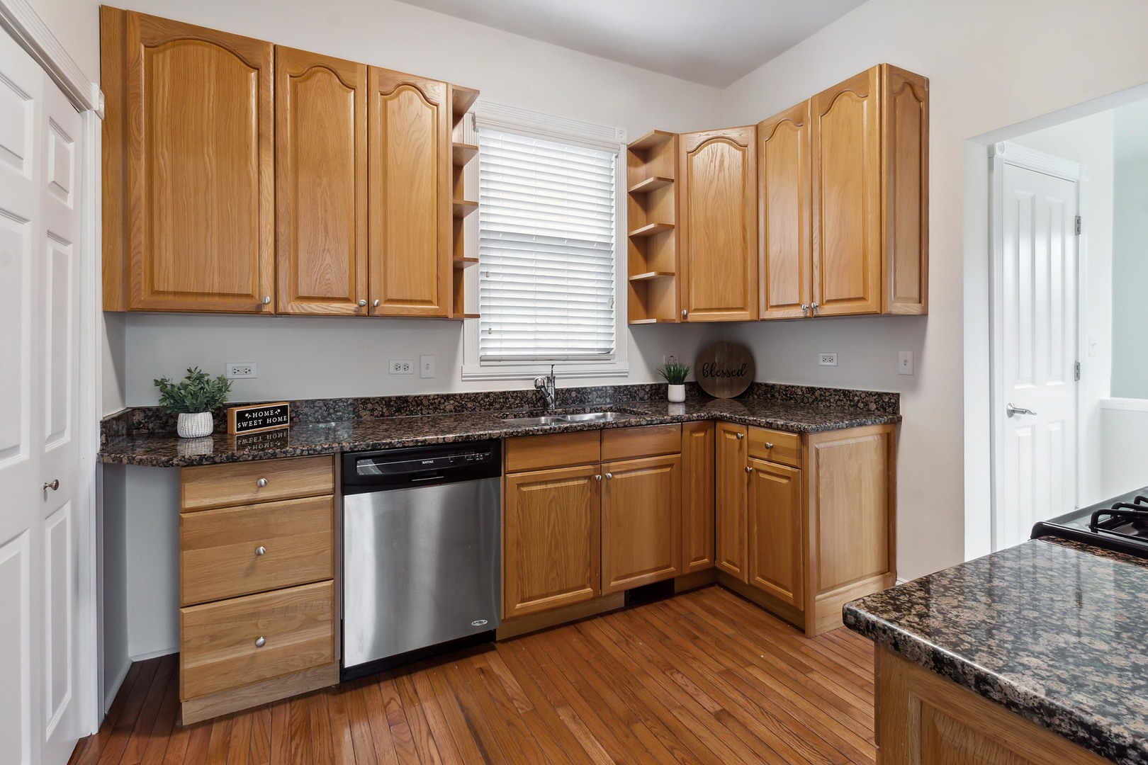 9430 Jackson Avenue Brookfield, IL 60513 - Photo 5 of 17 a kitchen with granite countertop wooden cabinets and a stove