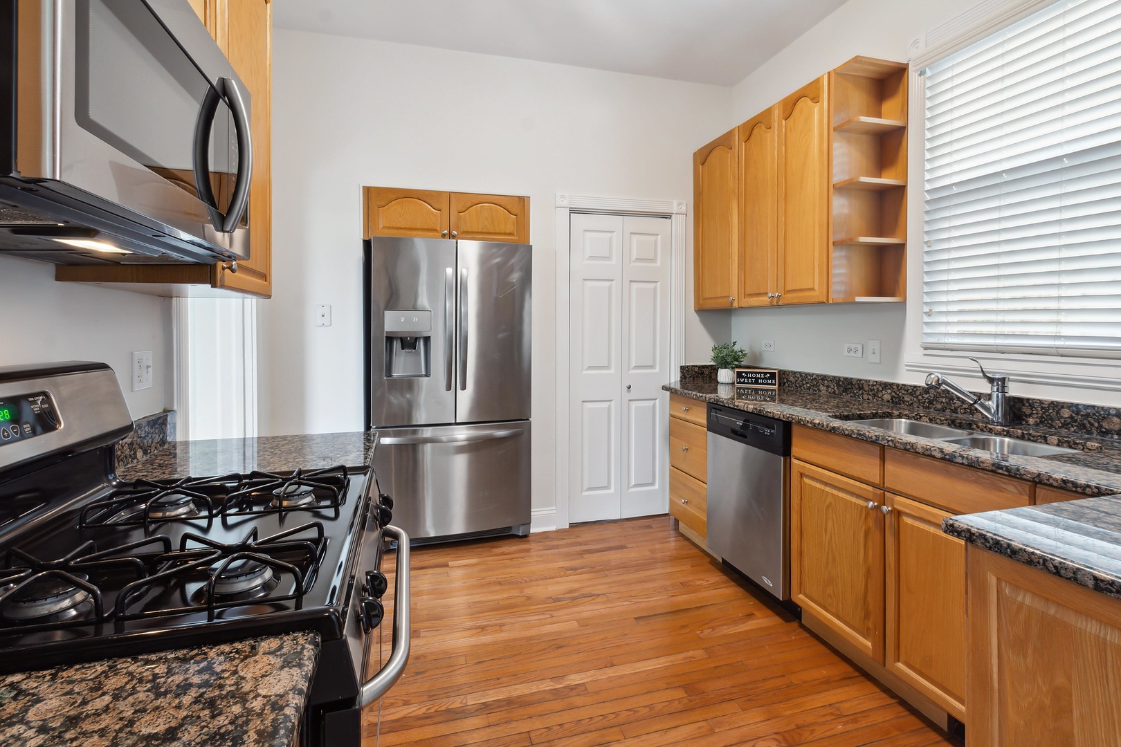 9430 Jackson Avenue Brookfield, IL 60513 - Photo 6 of 17 a kitchen with granite countertop a refrigerator stove top oven and sink