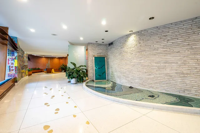 a view of a living room with a chandelier and entryway