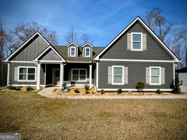 a front view of a house with outdoor seating