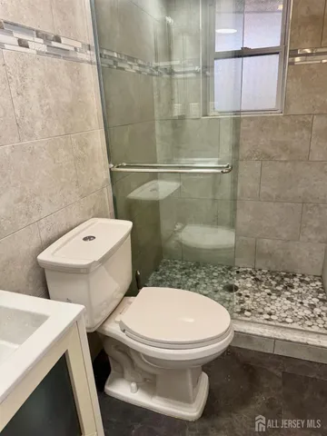 a white toilet sitting next to a bathroom sink