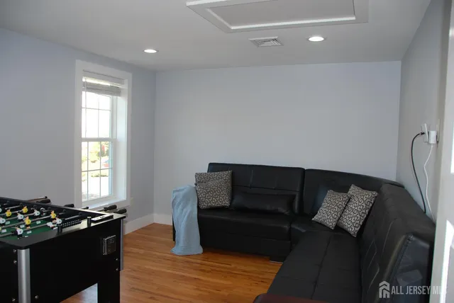 a living room with furniture a couch and a window