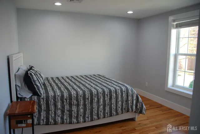 a bed sitting in a bedroom next to a window