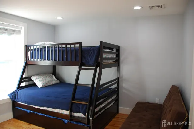 a bedroom with furniture and a window