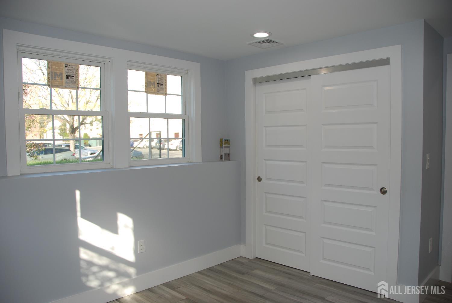 229 Monroe Street Rahway, NJ 07065 - Photo 9 of 15 a view of an empty room with wooden floor and a window