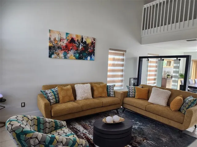 a living room with furniture and a large window