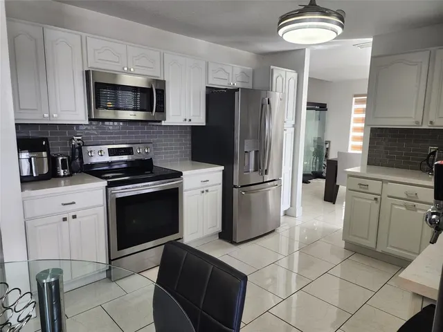 a kitchen with a refrigerator stove and sink