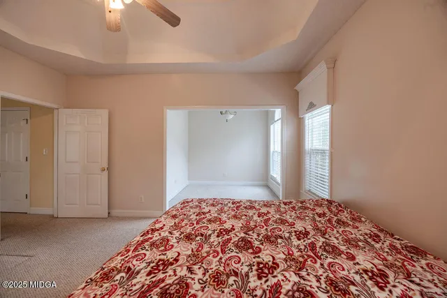 a bedroom with a bed and a lamp