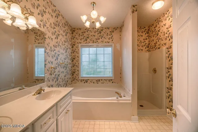 a bathroom with a tub sink and shower
