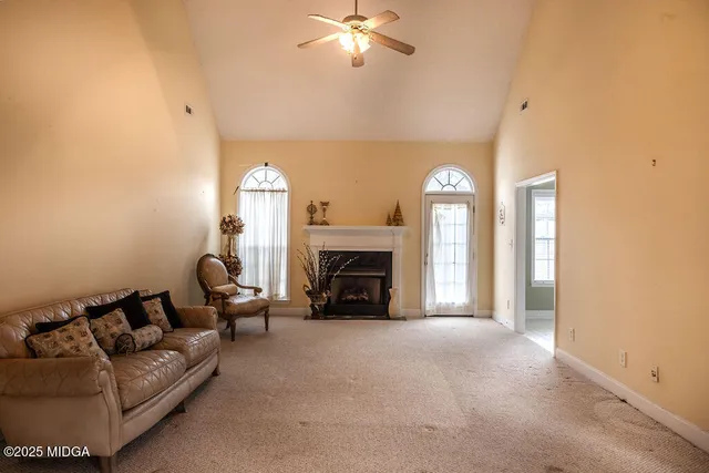 a living room with furniture and a fireplace