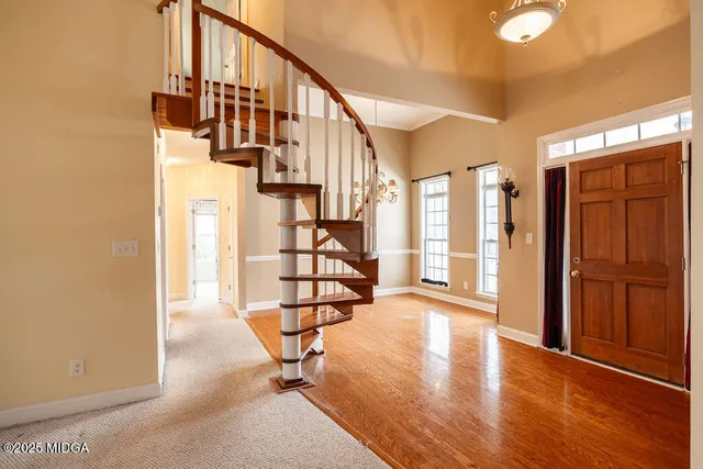 a view of an entryway with wooden floor and door