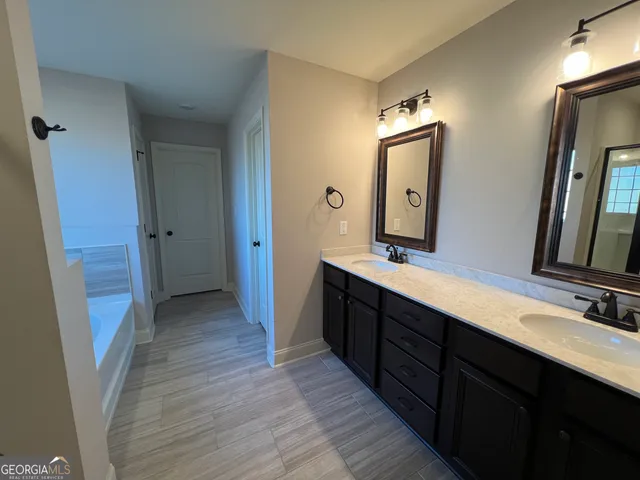 a bathroom with a double vanity sink and mirror