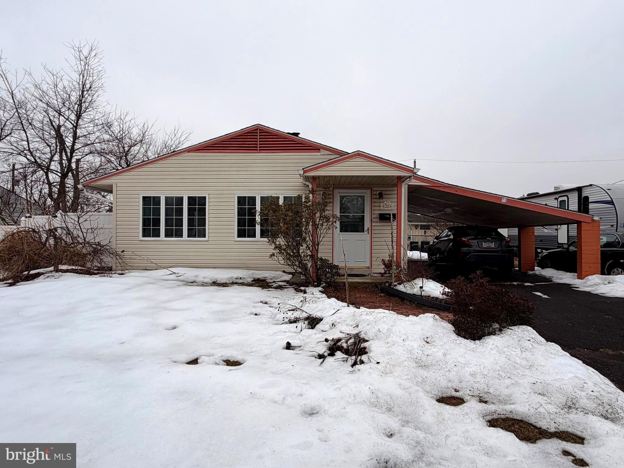 25 Balsam Road Levittown, PA 19057 - Photo 1 of 17 a front view of a house with a yard covered in snow