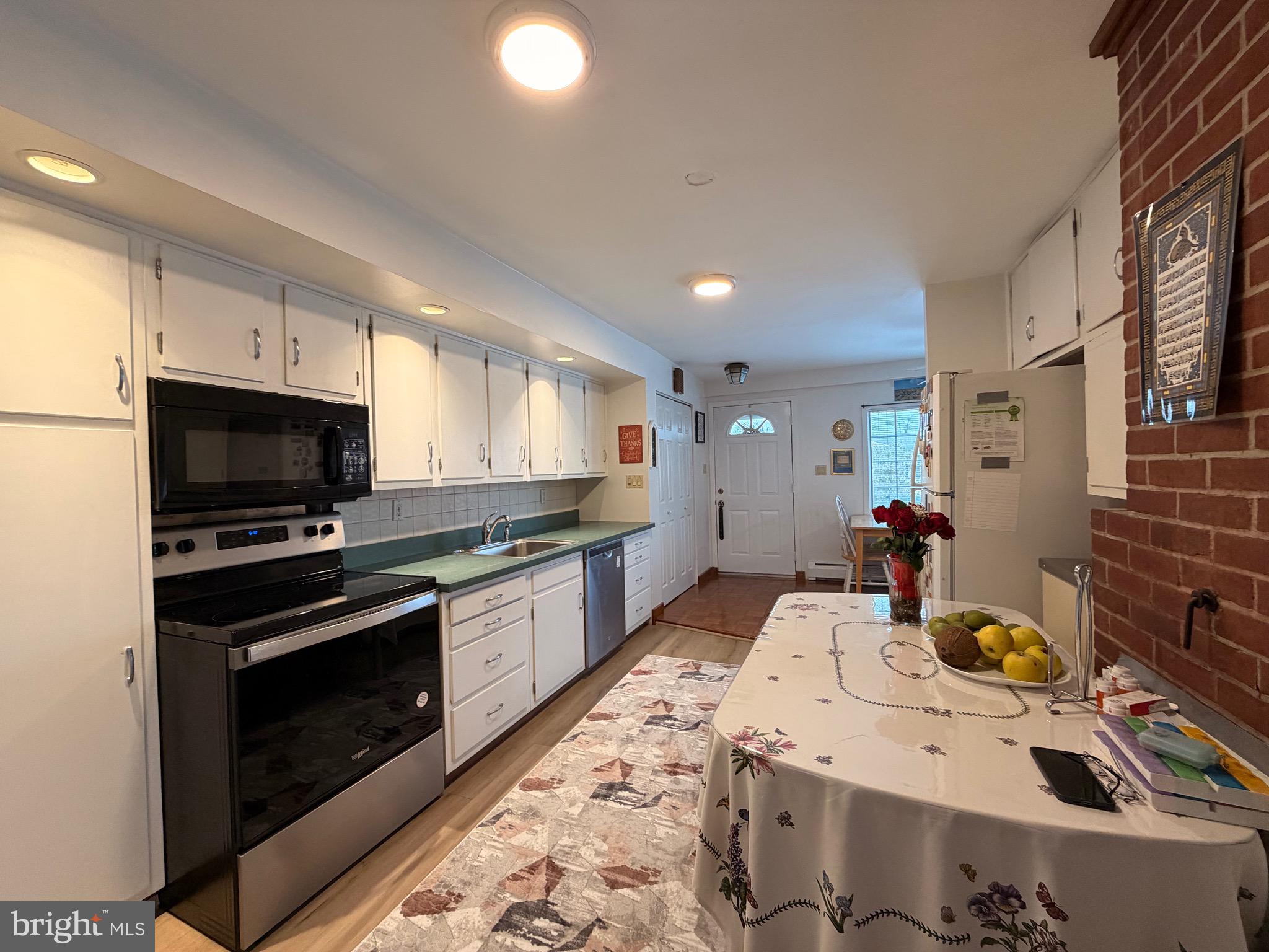 25 Balsam Road Levittown, PA 19057 - Photo 10 of 17 a kitchen with a stove a sink and a microwave
