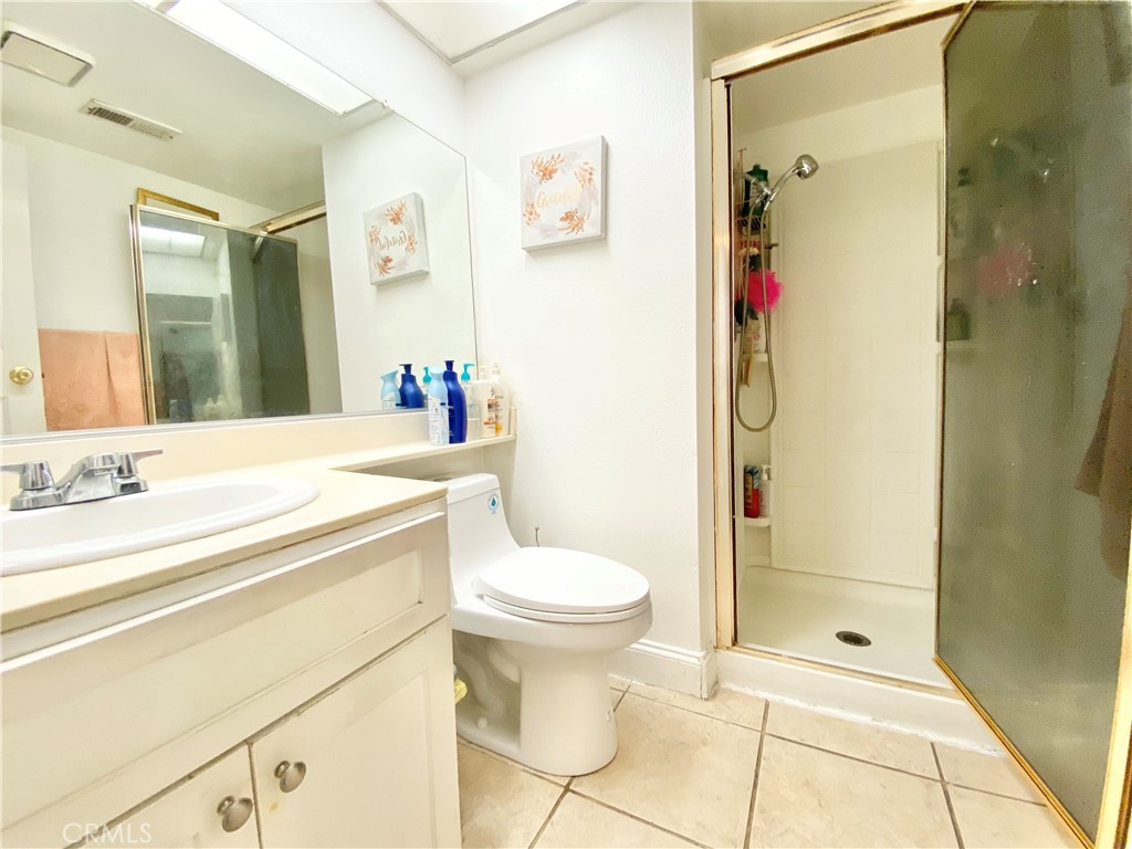 1444 North Sage Avenue Rialto, CA 92376 - Photo 11 of 22 a bathroom with a sink toilet and shower