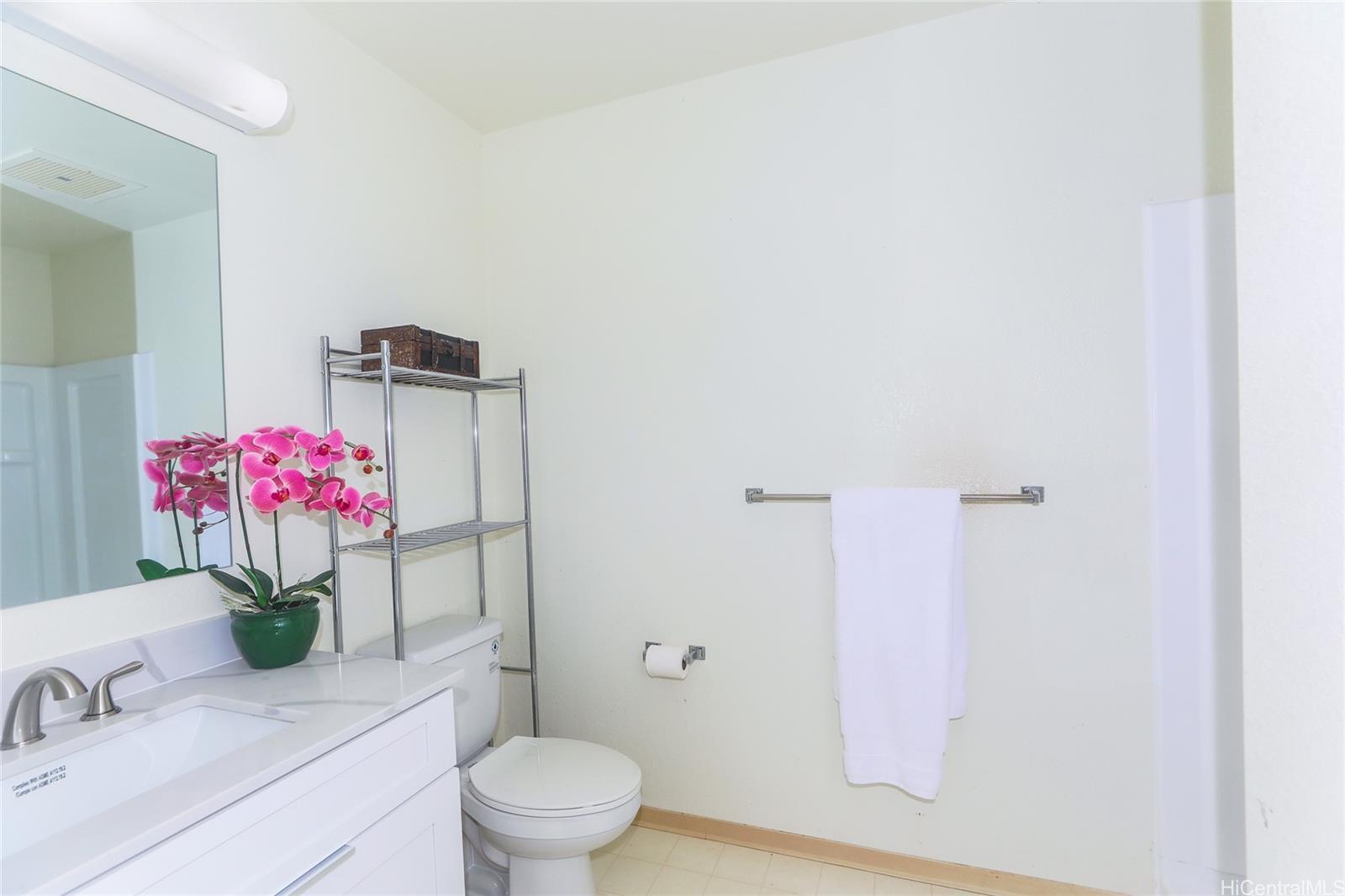 94-508 Kupuohi Street, Unit 8103 Waipahu, HI 96797 - Photo 12 of 19 a bathroom with a sink mirror and toilet