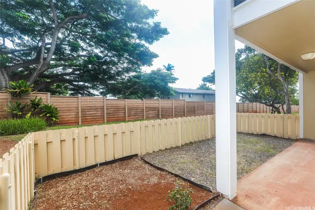 a view of a backyard with wooden fence