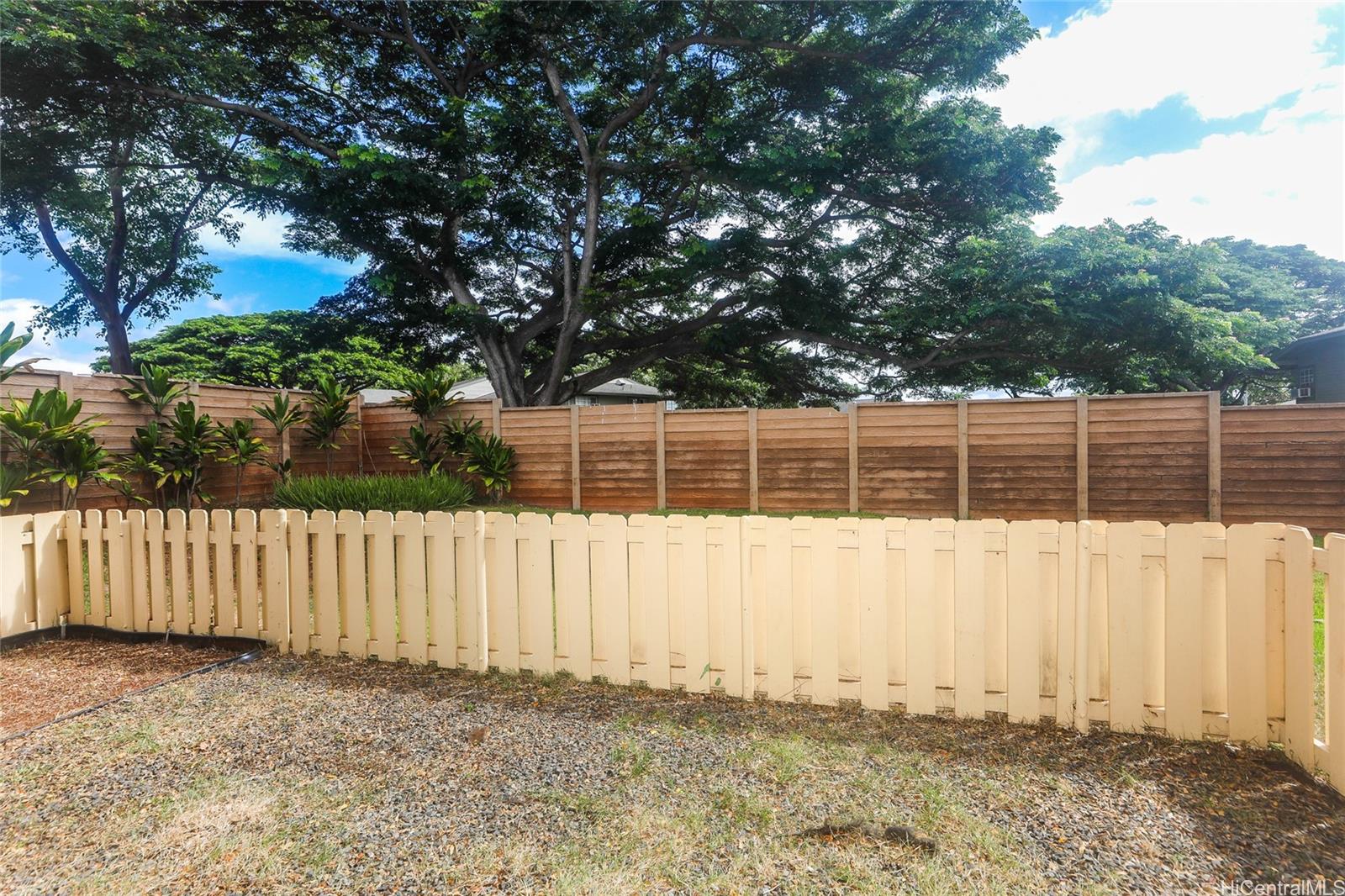 94-508 Kupuohi Street, Unit 8103 Waipahu, HI 96797 - Photo 19 of 19 a front view of a house with a fence