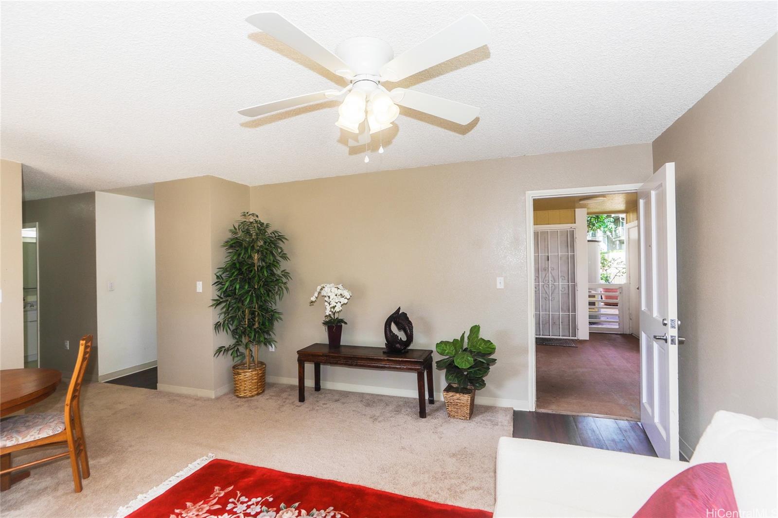 94-508 Kupuohi Street, Unit 8103 Waipahu, HI 96797 - Photo 5 of 19 a living room with furniture and a potted plant