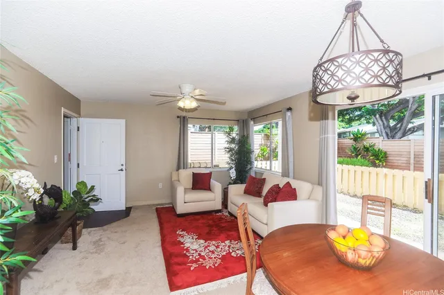 a living room with furniture chandelier and a table