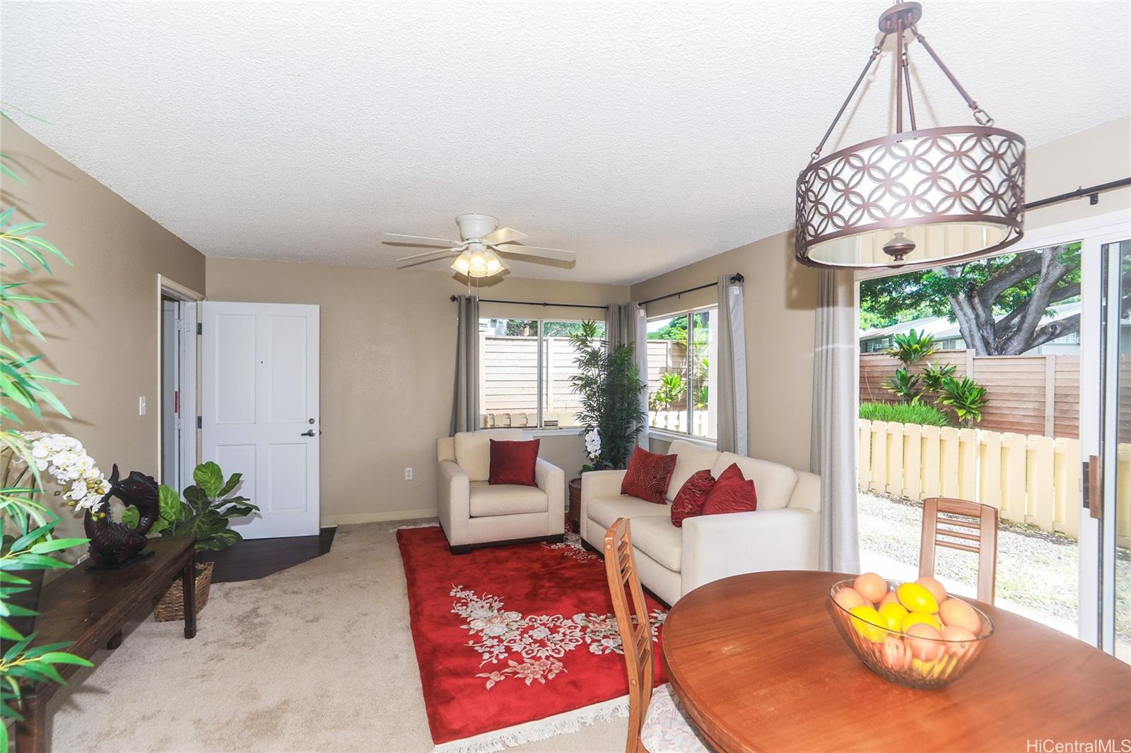 94-508 Kupuohi Street, Unit 8103 Waipahu, HI 96797 - Photo 6 of 19 a living room with furniture chandelier and a table
