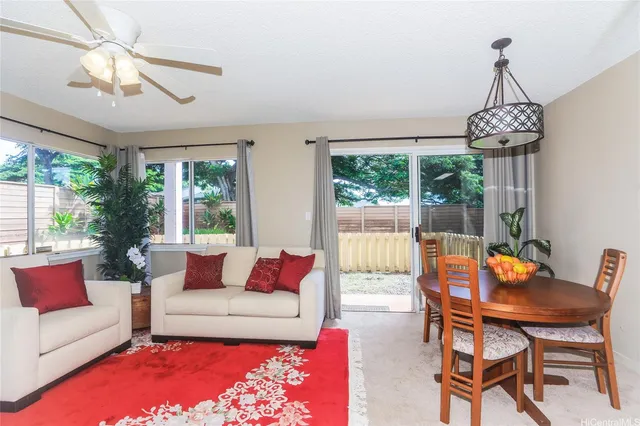 a living room with furniture a chandelier and a large window