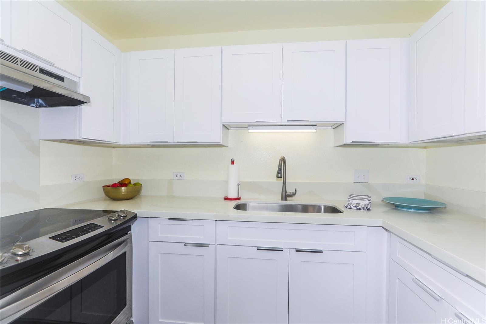 94-508 Kupuohi Street, Unit 8103 Waipahu, HI 96797 - Photo 9 of 19 a kitchen with a sink cabinets and stainless steel appliances