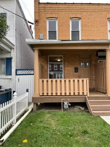 a view of a house with wooden fence