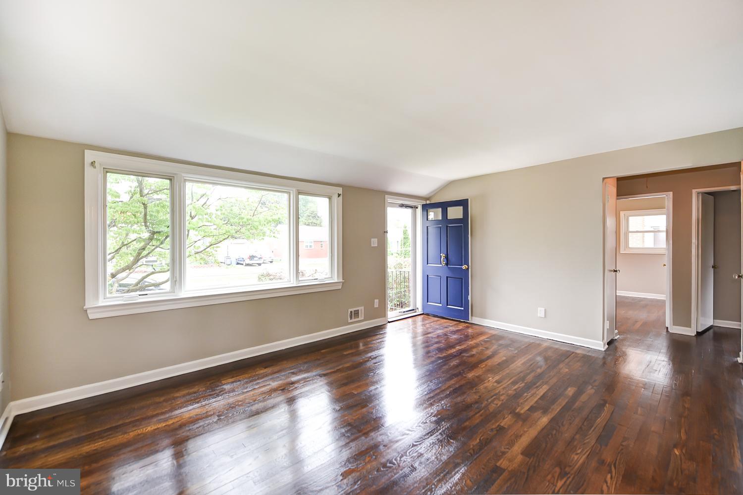 12816 Matey Road Silver Spring, MD 20906 - Photo 2 of 30 a view of an empty room with wooden floor and a window