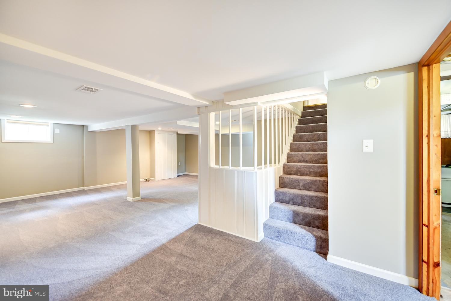 12816 Matey Road Silver Spring, MD 20906 - Photo 15 of 30 a view of an empty room with wooden floor and stairs