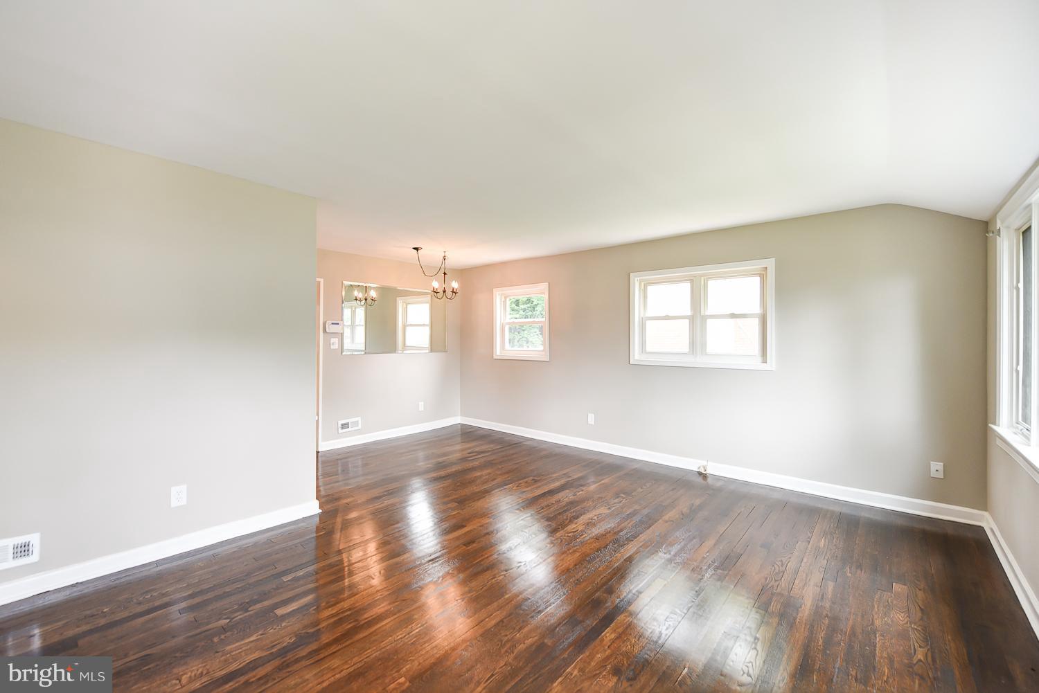 12816 Matey Road Silver Spring, MD 20906 - Photo 3 of 30 an empty room with wooden floor and windows