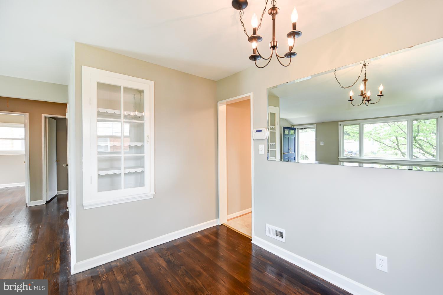 12816 Matey Road Silver Spring, MD 20906 - Photo 4 of 30 a view of an empty room with wooden floor and a window