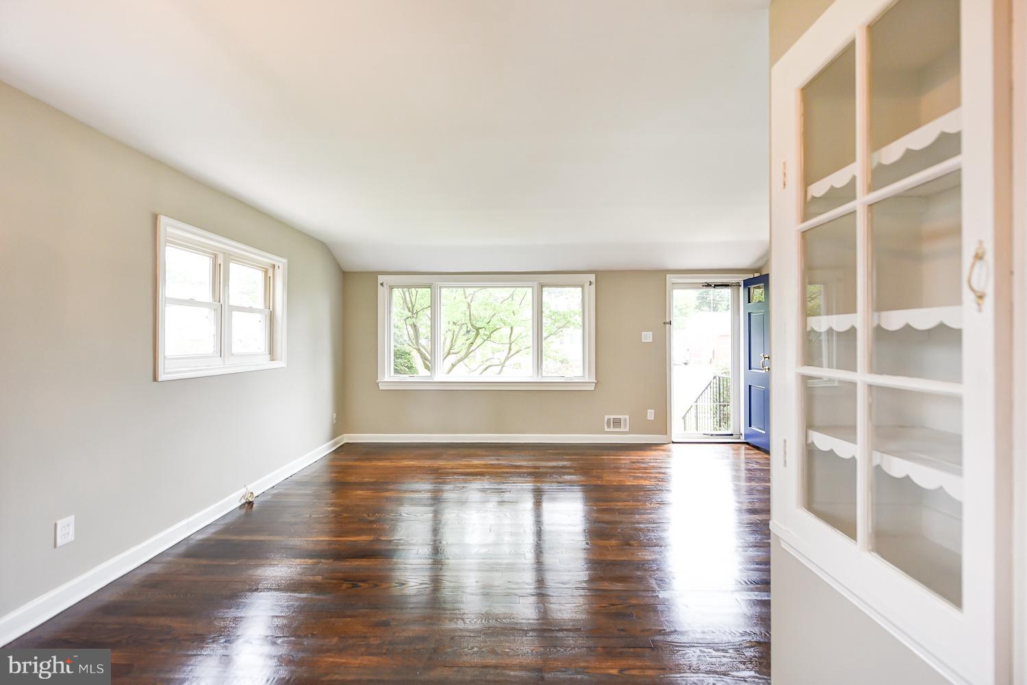12816 Matey Road Silver Spring, MD 20906 - Photo 5 of 30 a view of an empty room with wooden floor and a window