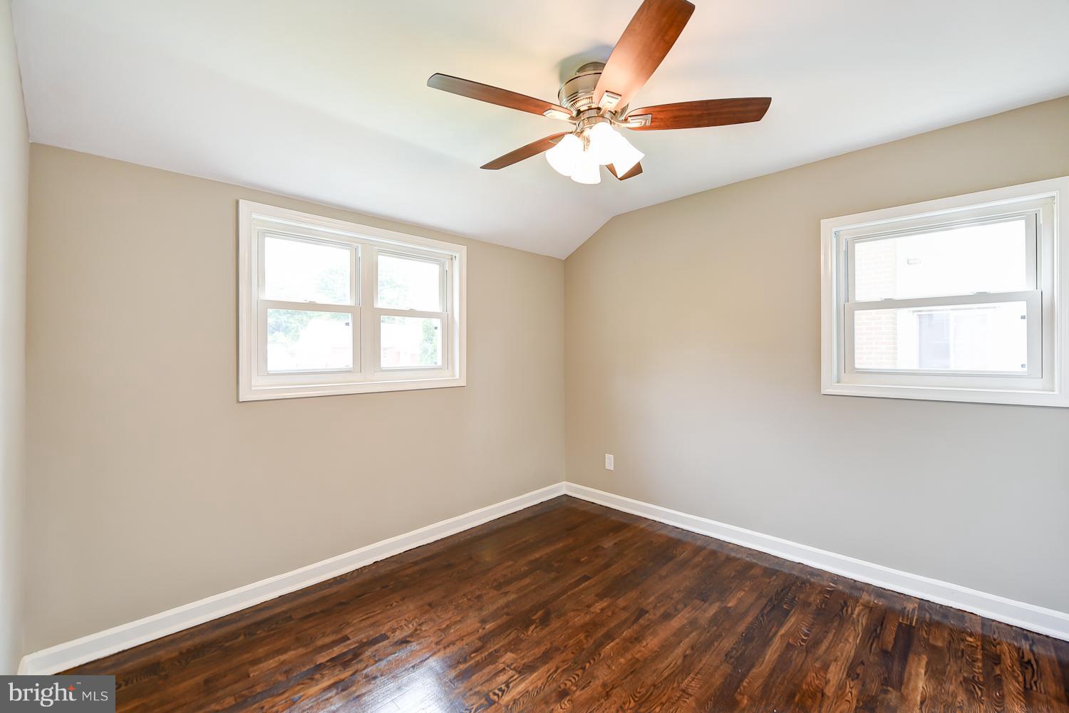 12816 Matey Road Silver Spring, MD 20906 - Photo 8 of 30 a view of an empty room with wooden floor and a window