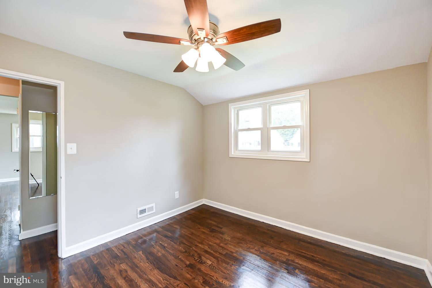12816 Matey Road Silver Spring, MD 20906 - Photo 9 of 30 wooden floor in an empty room with a window