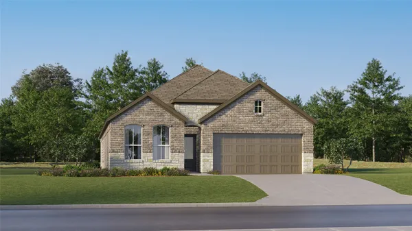 a front view of a house with a garden and yard