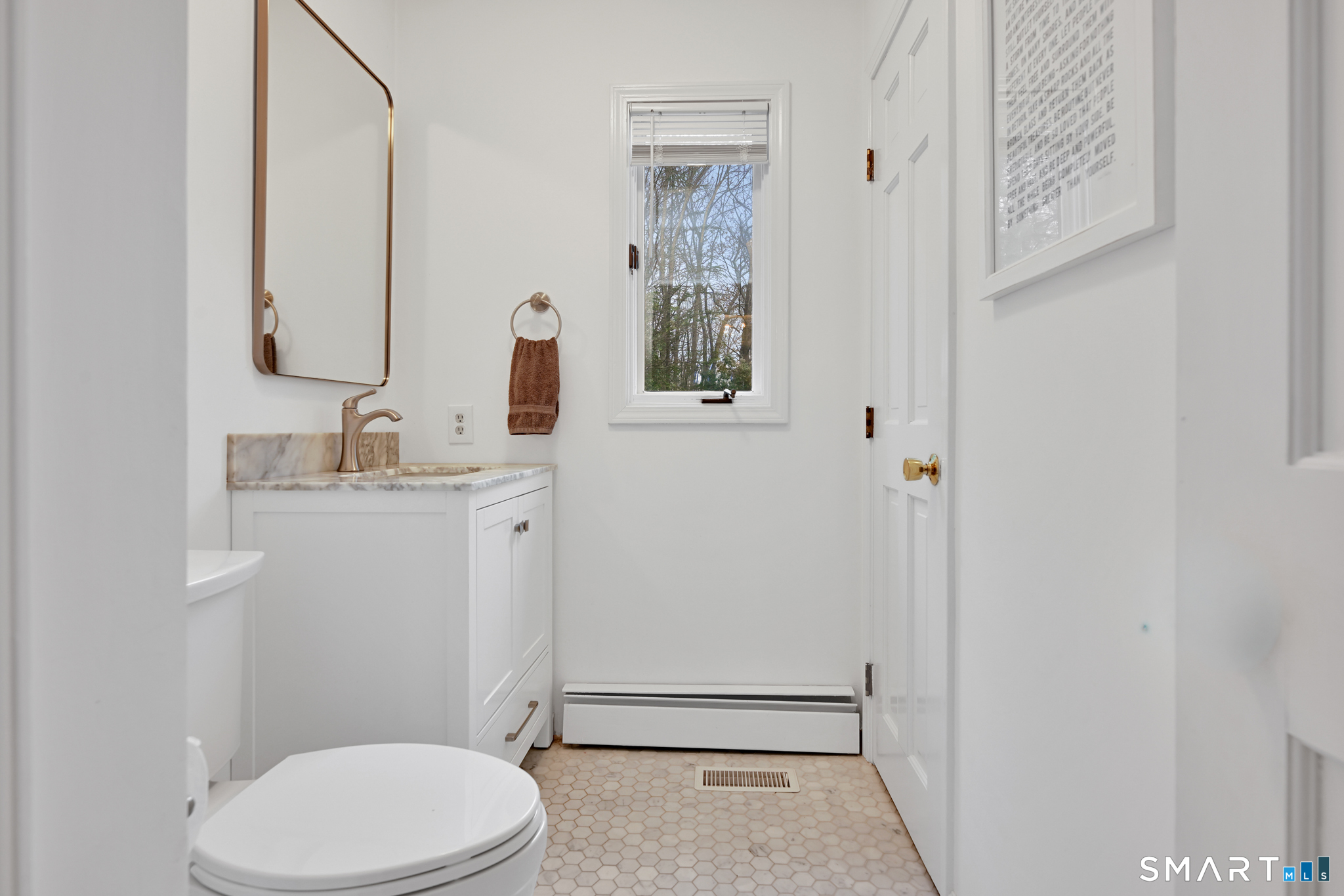 117 Settlers Farm Road Monroe, CT 06468 - Photo 16 of 40 The updated powder room has luxurious marble mosaic floor tiles that create a sophisticated atmosphere.