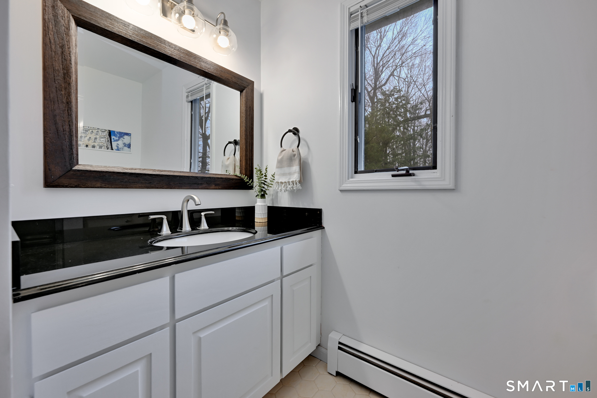 117 Settlers Farm Road Monroe, CT 06468 - Photo 21 of 40 The suite also boasts a full bathroom, featuring a modern vanity and mirror.