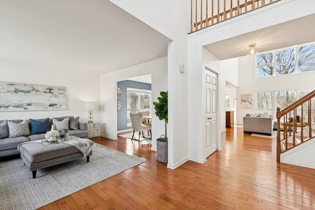 a living room with furniture and a large window with outer view