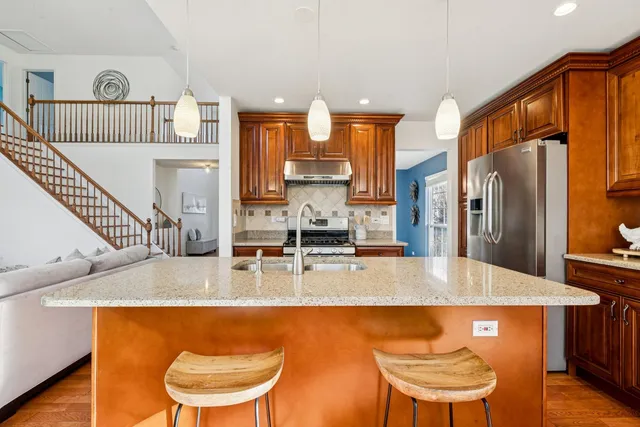 a kitchen with stainless steel appliances granite countertop a stove and a refrigerator