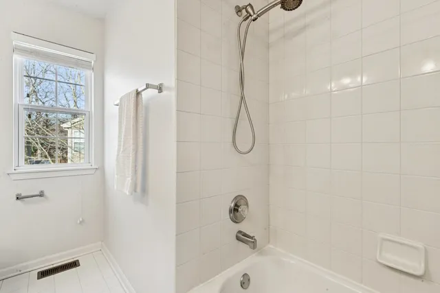 a bathroom with a bathtub and a shower