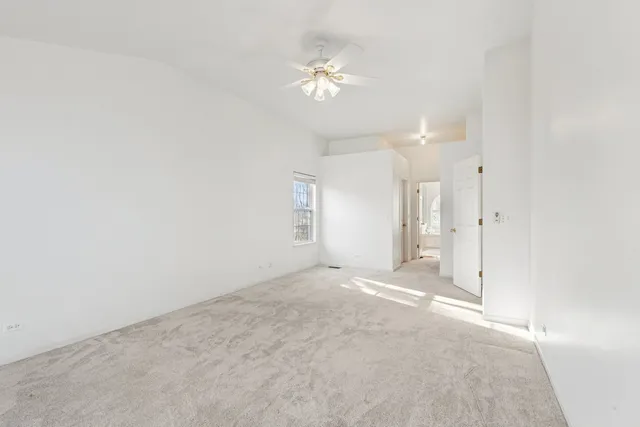 a view of a kitchen with kitchen island a sink stainless steel appliances and a counter top space